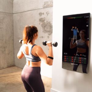 Product image of the Echelon Reflect showing a woman working out with dumbbells in front of the reflective screen.